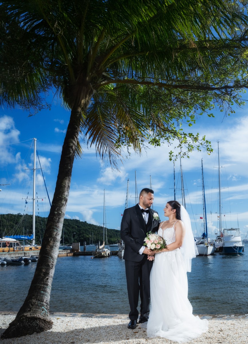 Wedding couple photographed beside a marina