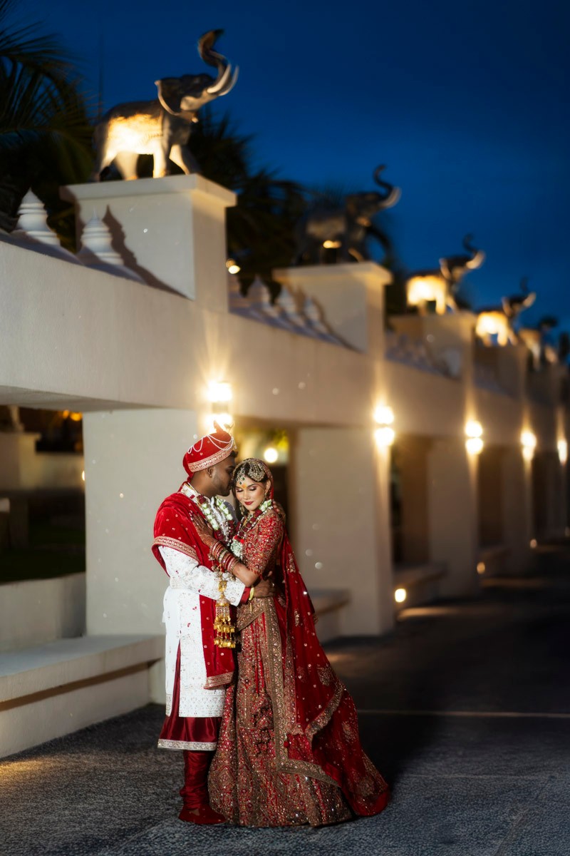 Traditionally dressed wedding couple embracing