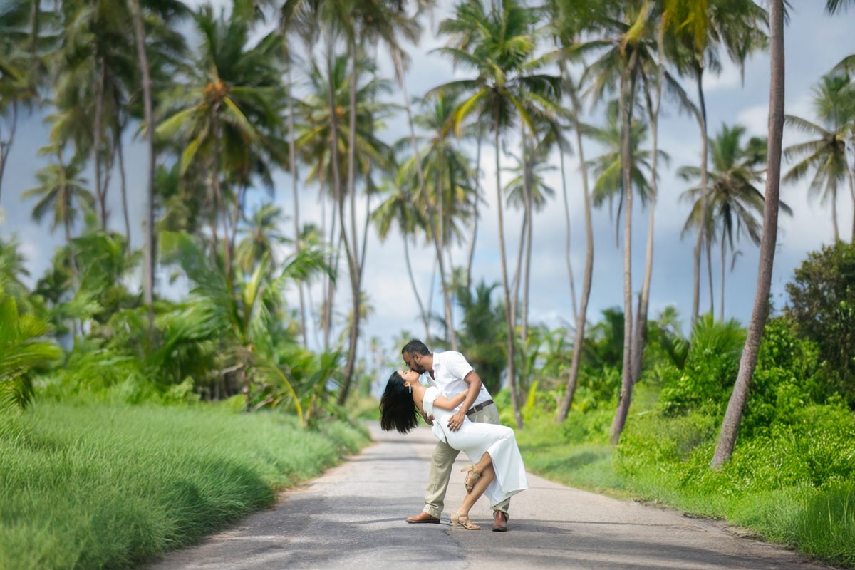 Couple photographed on a palm-lined road in Trinidad